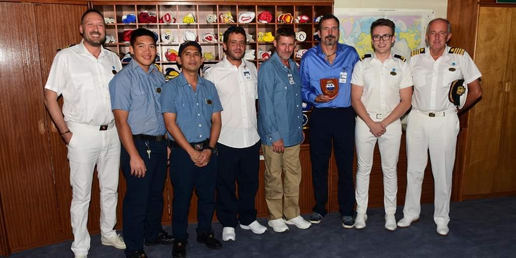 Group shot of Max, the rescue boat crew, captain, staff captain of the ship and 3 men that were rescued